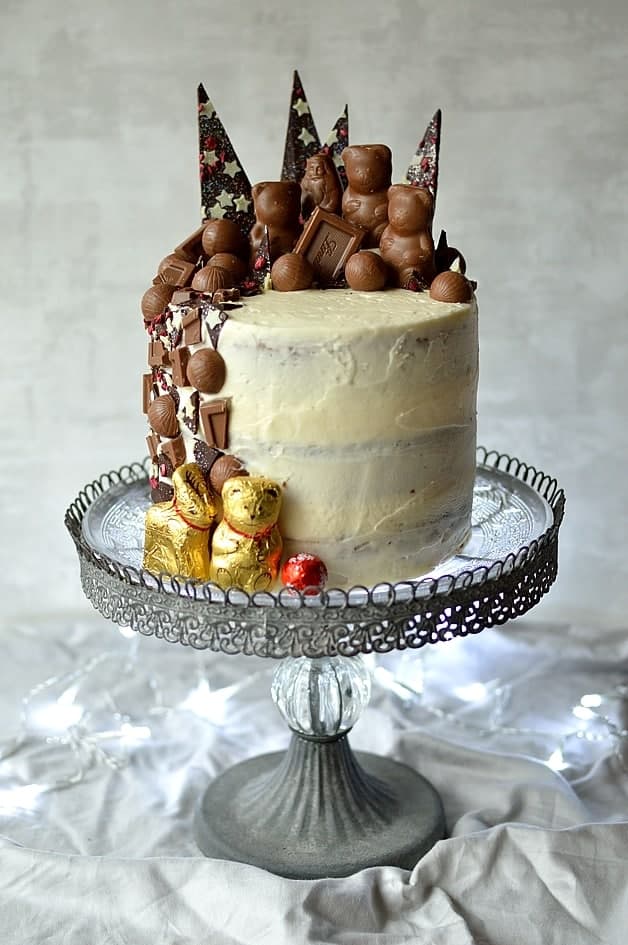 Moist brown sugar buttermilk spice cake with smooth, creamy vanilla mascarpone frosting and Lindt chocolate decorations, perfect for the festive season.
