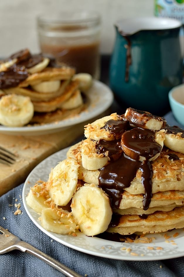 Toasted coconut pancakes with coconut milk chocolate fudge sauce and banana, an utterly delicious and decadent breakfast or brunch (dairy-free)