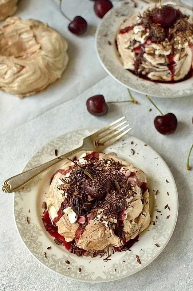 Black forest meringue nests - chocolate swirl meringues with quark whipped cream, cherry compote & chocolate shavings