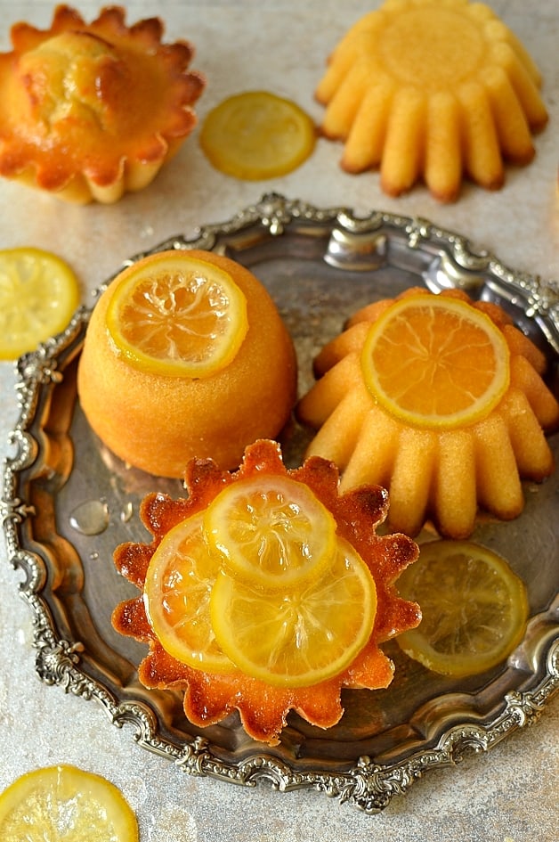 Mini syrupy lemon, olive oil and semolina cakes with candied lemon slices