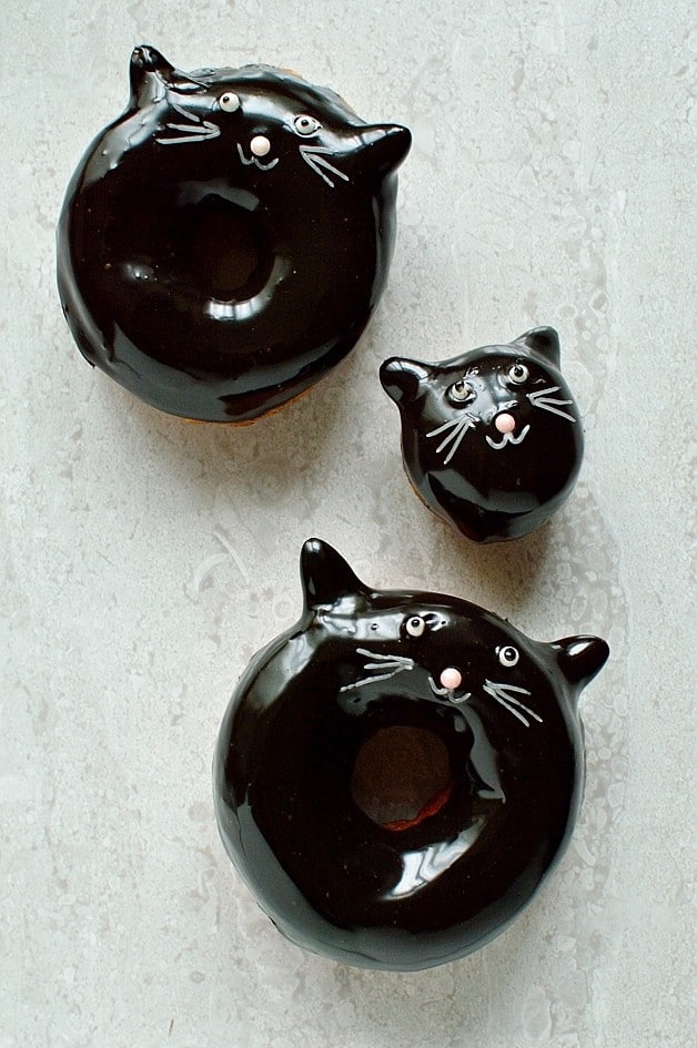 Chocolate glazed fried doughnuts with a cute (and easy) black cat design, a perfect treat for Halloween!