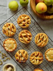 Mini apple hand pies baked in a muffin tin spiced with cardamom and cinnamon