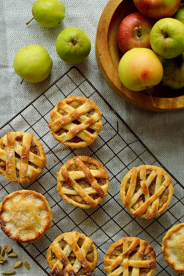 Mini apple hand pies baked in a muffin tin spiced with cardamom and cinnamon