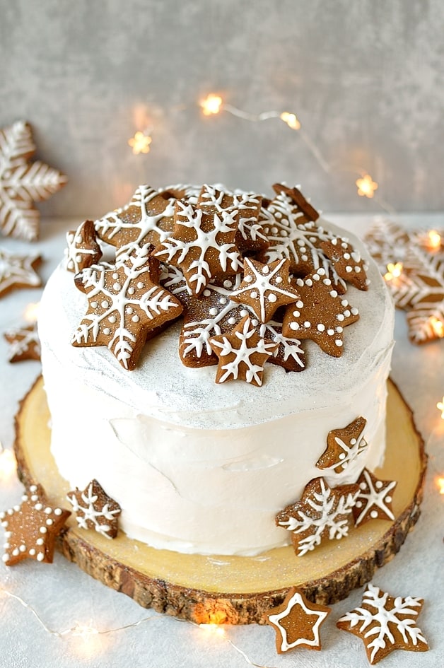 Rich Christmas fruitcake topped with marzipan, royal icing and gingerbread stars and snowflakes