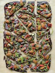 Superfood chocolate bark - dark chocolate topped with almonds, goji berries, seeds, bee pollen and white chocolate flavoured with matcha and freeze dried blueberry powder