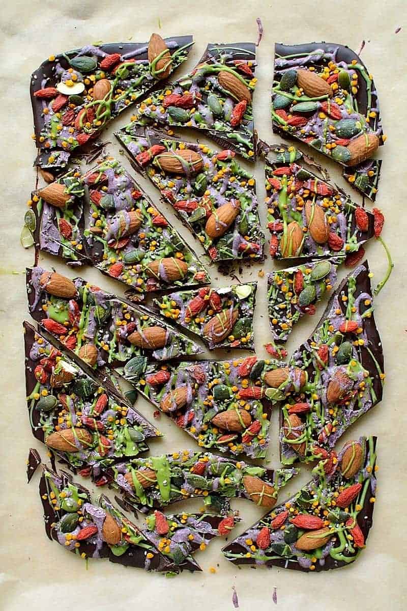 Superfood chocolate bark - dark chocolate topped with almonds, goji berries, seeds, bee pollen and white chocolate flavoured with matcha and freeze dried blueberry powder