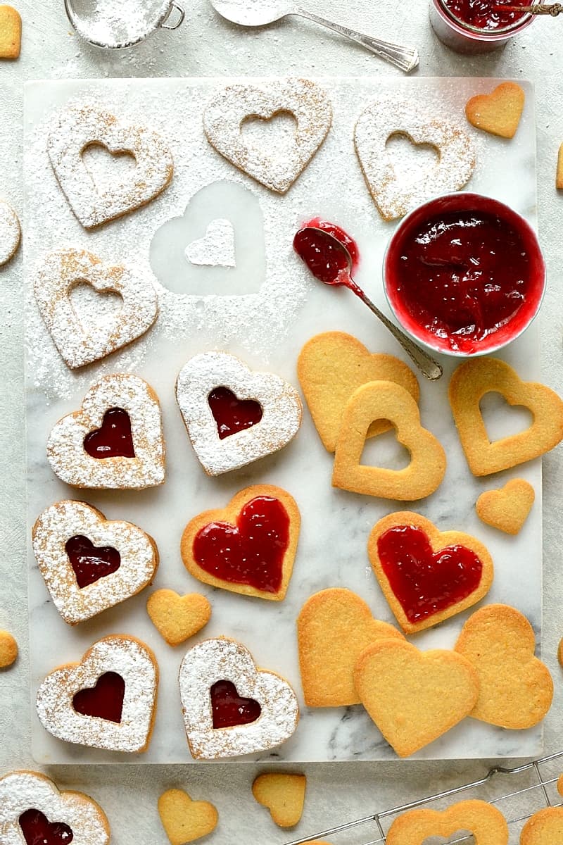 Valentine's Day Linzer biscuits (cookies) - delicious heart shaped almond biscuits filled with raspberry jam.