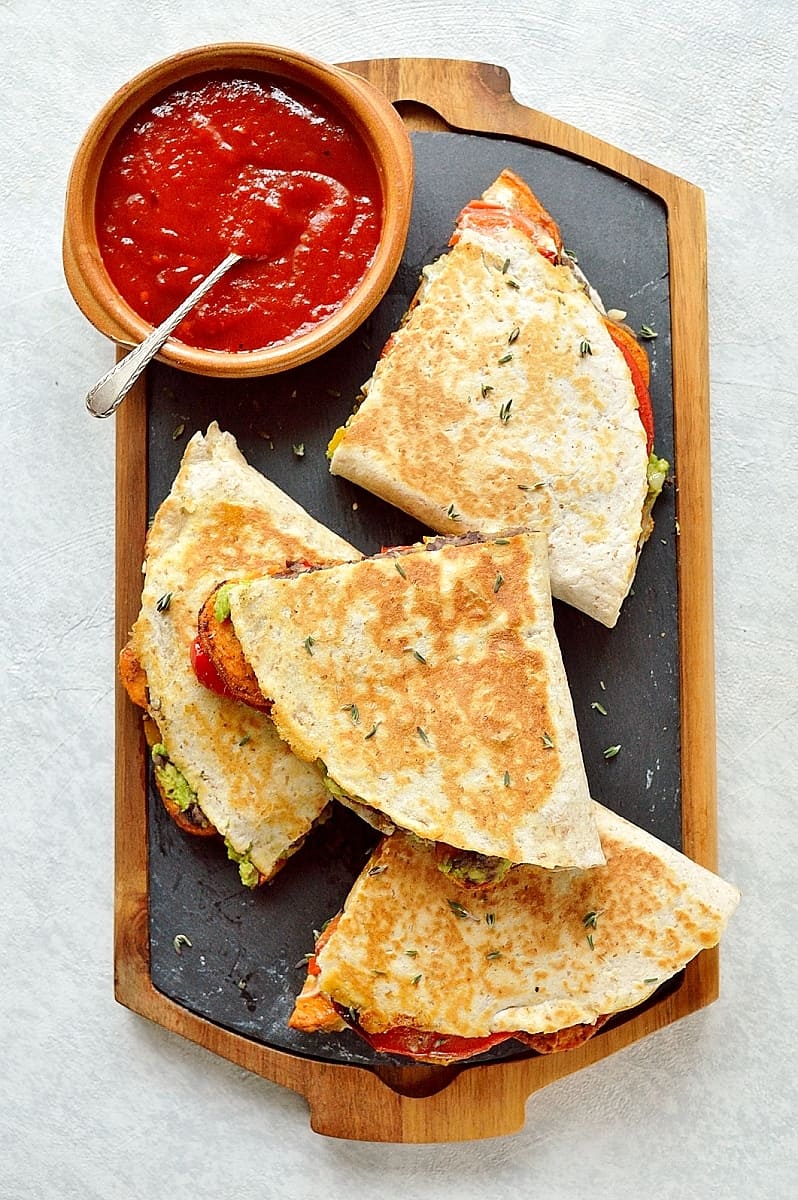 Loaded veggie quesadillas - delicious, filling, healthy quesadillas stuffed with spiced roasted sweet potato, peppers, black beans, avocado, cream cheese and cheddar.