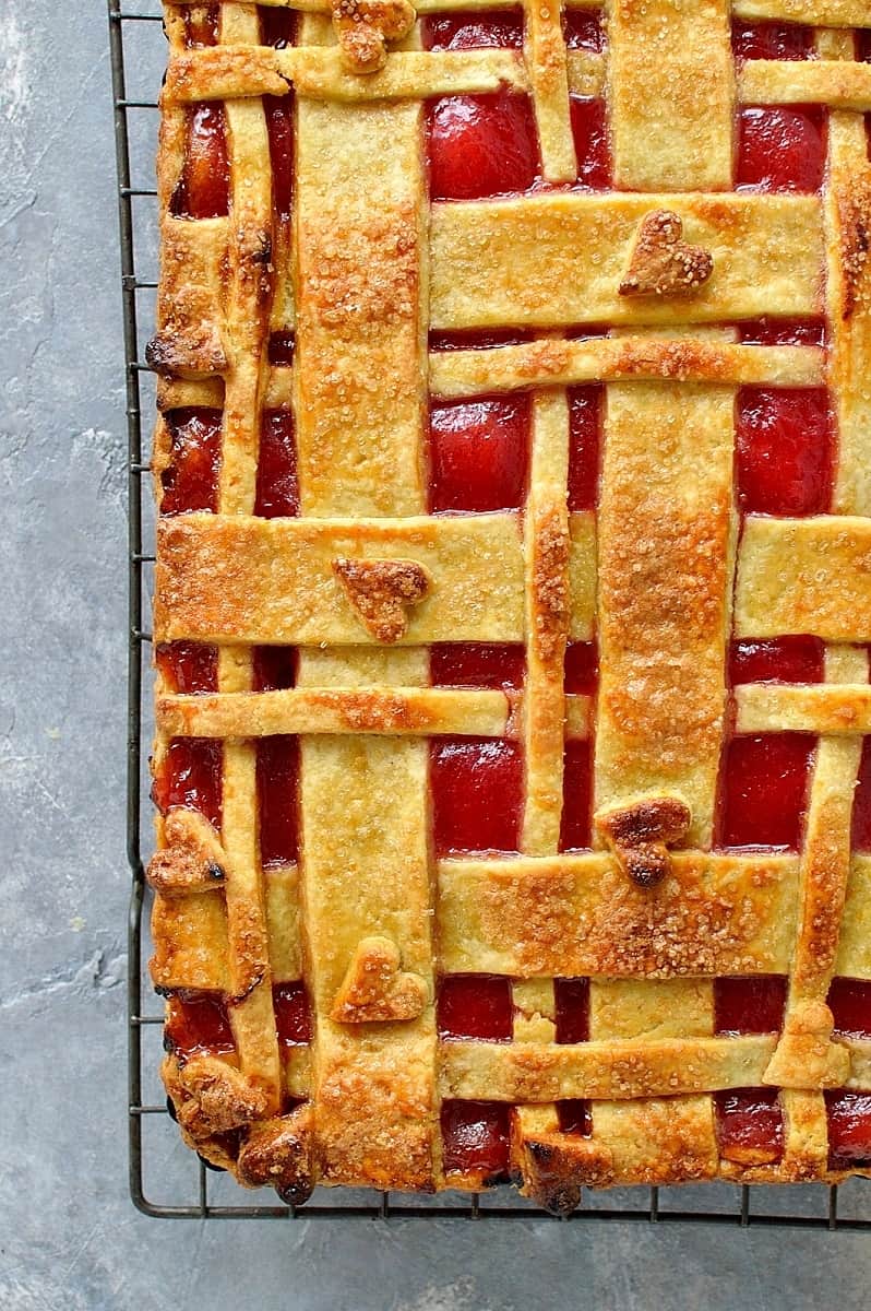 Rhubarb orange almond pie - crisp orange pastry filled with almond and orange frangipane and tart rhubarb compote, topped with a pretty lattice design.