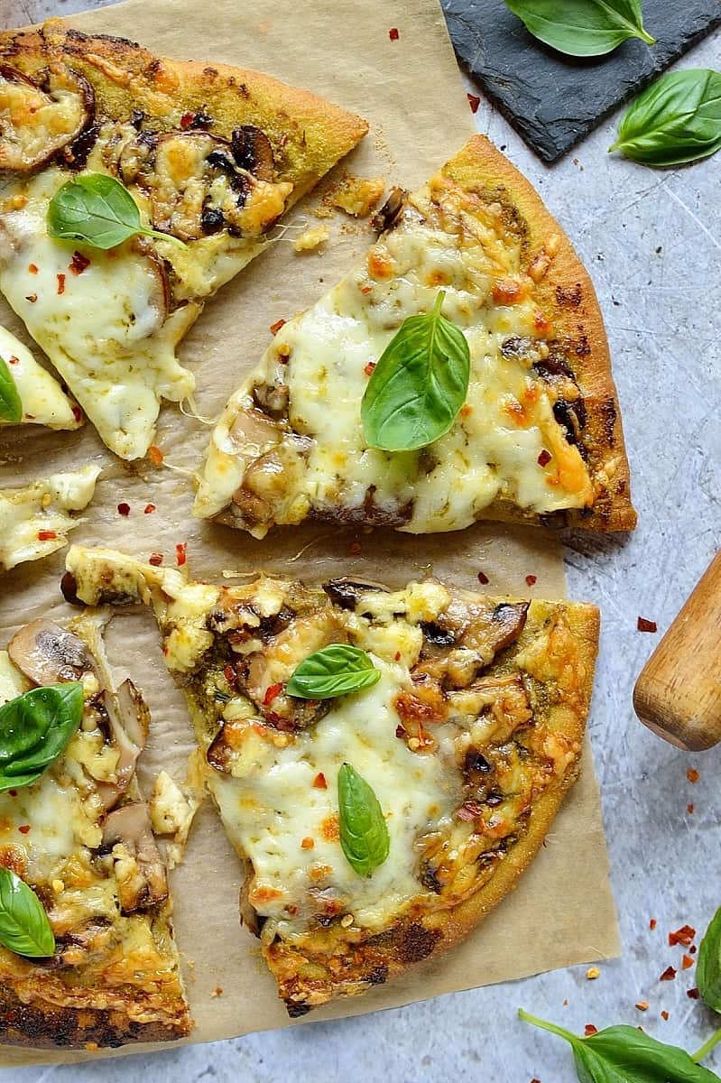 Mushroom pesto pizza - easy home made vegetarian pizza topped with garlic mushrooms, basil pesto and plenty of mozzarella and cheddar cheese.
