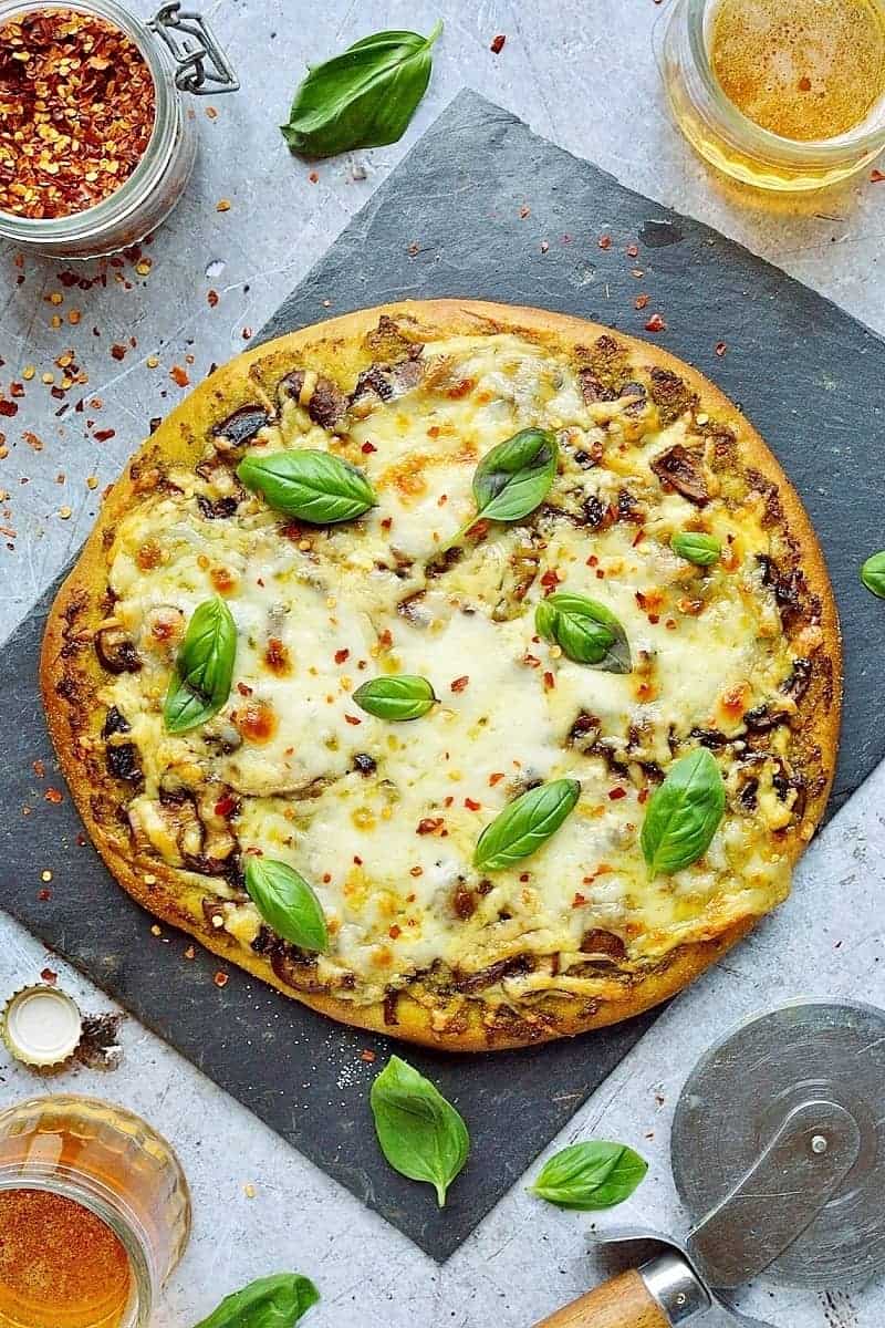 Mushroom pesto pizza - easy home made vegetarian pizza topped with garlic mushrooms, basil pesto and plenty of mozzarella and cheddar cheese.