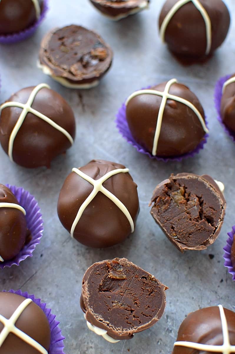 Hot cross bun chocolate truffles - rich, decadent chocolate ganache truffles flavoured with spices and mixed dried fruit, topped with a white chocolate cross.