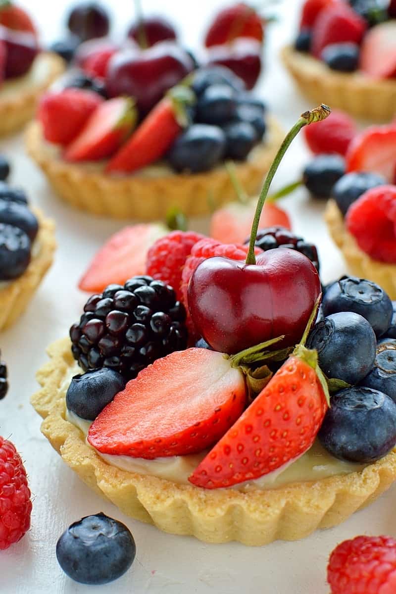 Coconut and berry fruit tarts - crisp coconut pastry with coconut pastry cream and fresh berries.
