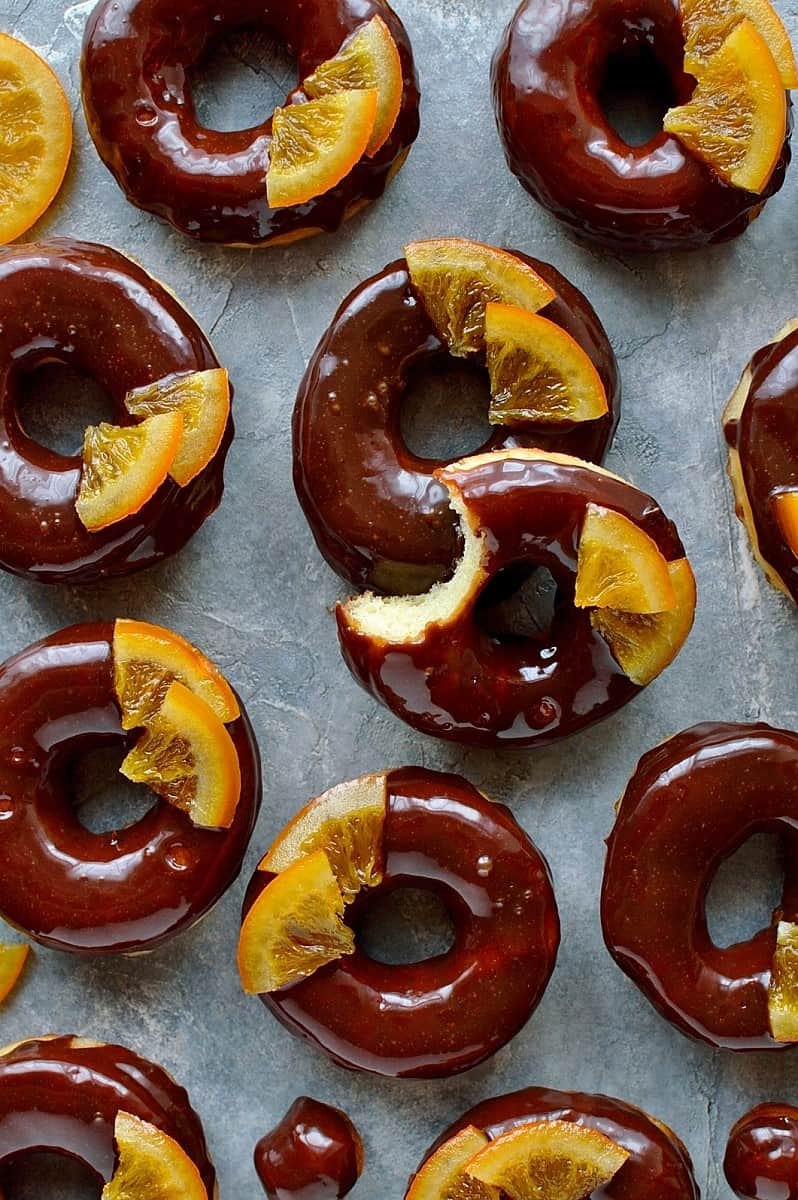 Chocolate orange doughnuts - light, soft, orange infused yeast doughnuts with chocolate orange glaze and candied oranges.