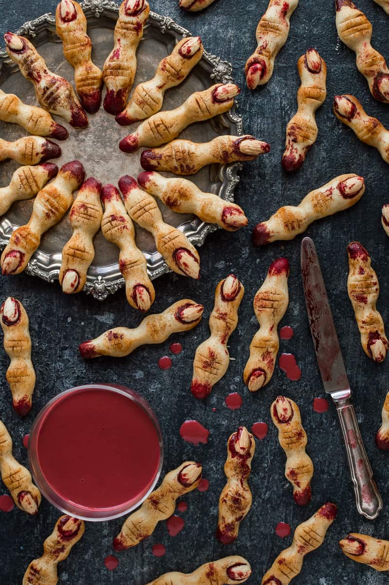 Witches' finger cookies with red velvet hot chocolate 'blood', a gory but delicious Halloween treat.