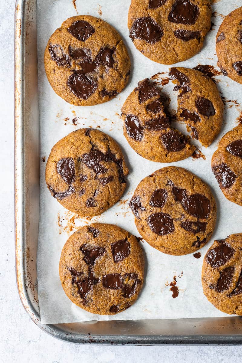 Vegan pumpkin chocolate chip cookies on a silver baking tray.