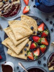 Vegan crepes with berry compote and chocolate sauce - easy, tender, egg and dairy free pancakes with a delectable chocolate sauce and mixed berry compote. Perfect for pancake day!