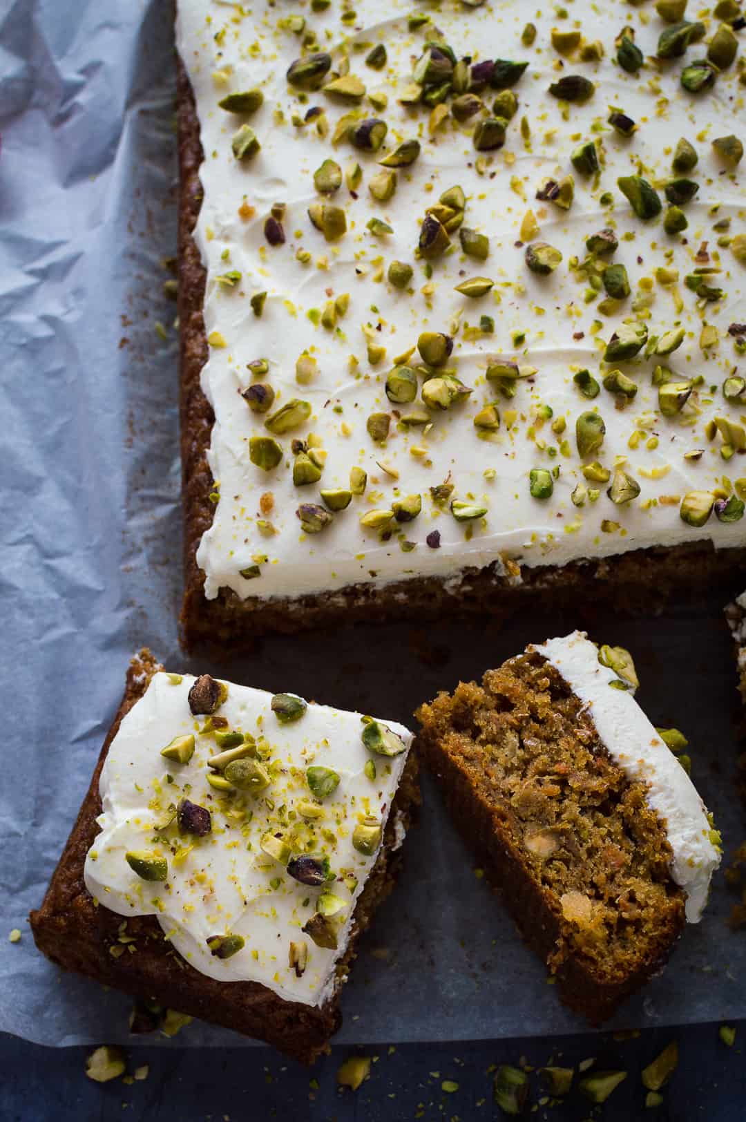 Carrot, pineapple and pistachio traybake topped with cream cheese icing and chopped pistachios.