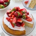 Vegan lemon almond cake with coconut whipped cream and macerated strawberries - a light, moist vegan lemon and almond cake topped with a cloud of coconut whipped cream and sweet macerated strawberries. The perfect cake for Spring!