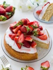 Vegan lemon almond cake with coconut whipped cream and macerated strawberries - a light, moist vegan lemon and almond cake topped with a cloud of coconut whipped cream and sweet macerated strawberries. The perfect cake for Spring!