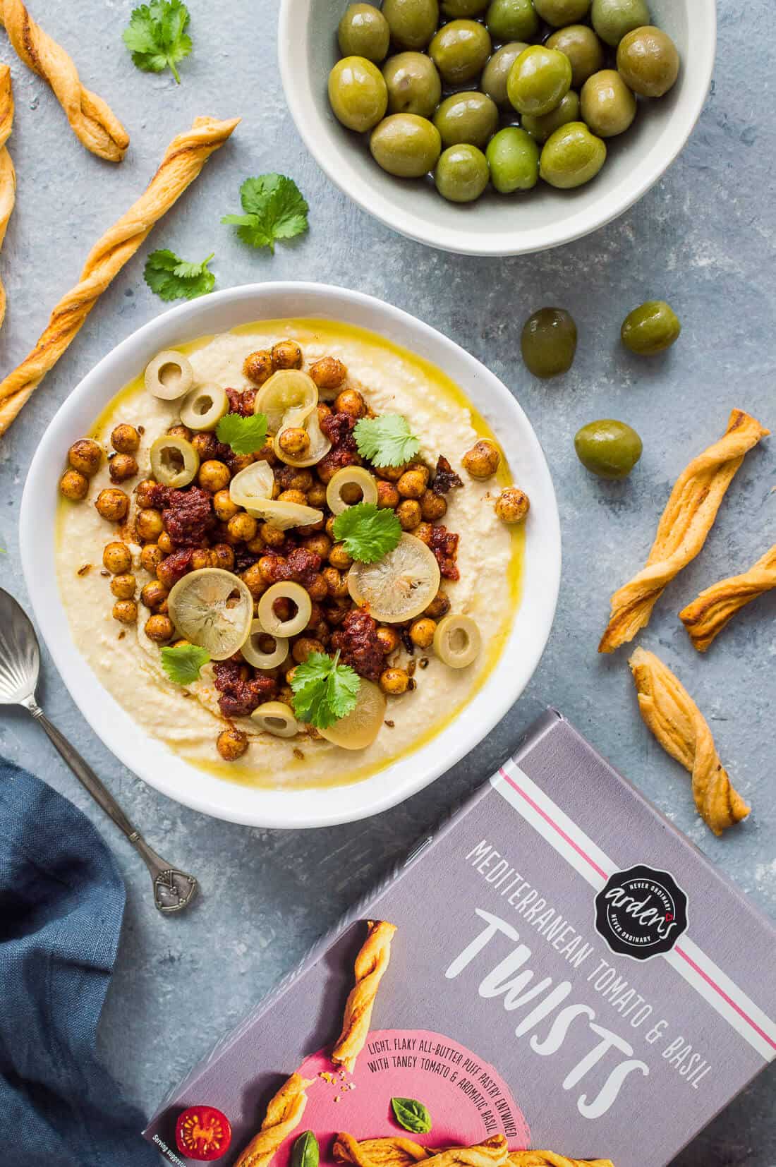 Spicy loaded hummus with crispy chickpeas, olives and Arden's mediterranean tomato and basil twists