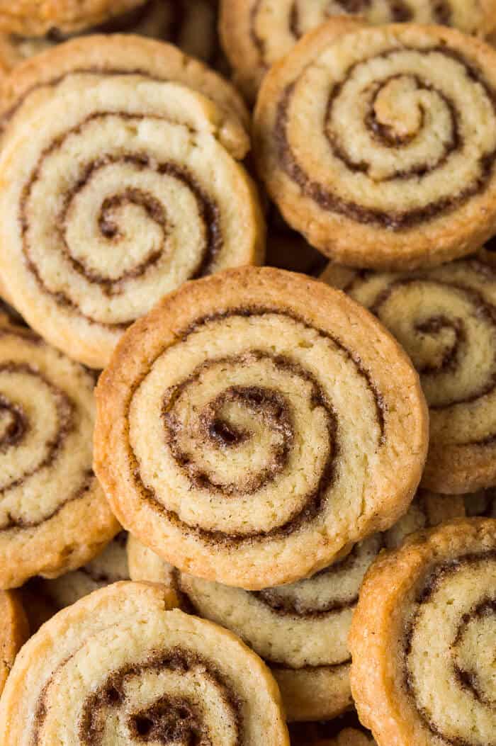 A close up of a pile of vegan cinnamon swirl cookies