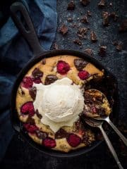 Chocolate raspberry skillet cookie for two - this indulgent vegan skillet cookie is really quick and easy to make, gooey in the middle and crisp around the edges. It is perfect for a romantic Valentine's day dessert to share! #vegan #skilletcookie