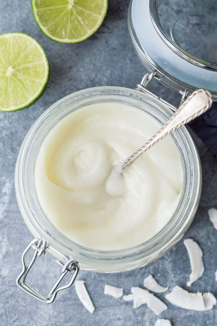 Close up of a jar of coconut lime curd.