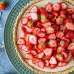 Close up of vegan strawberry tart on a green plate.