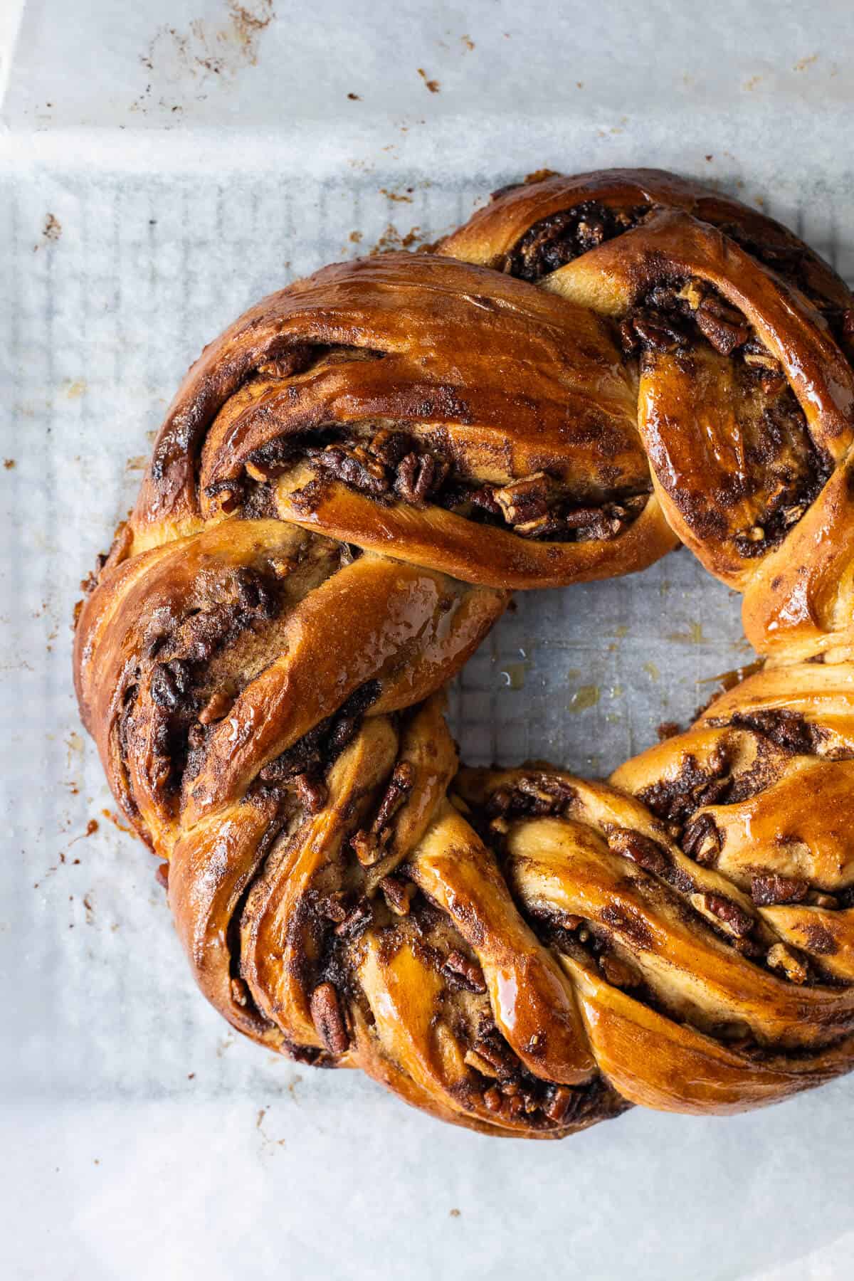 Close up of an unglazed loaf of maple pecan couronne.