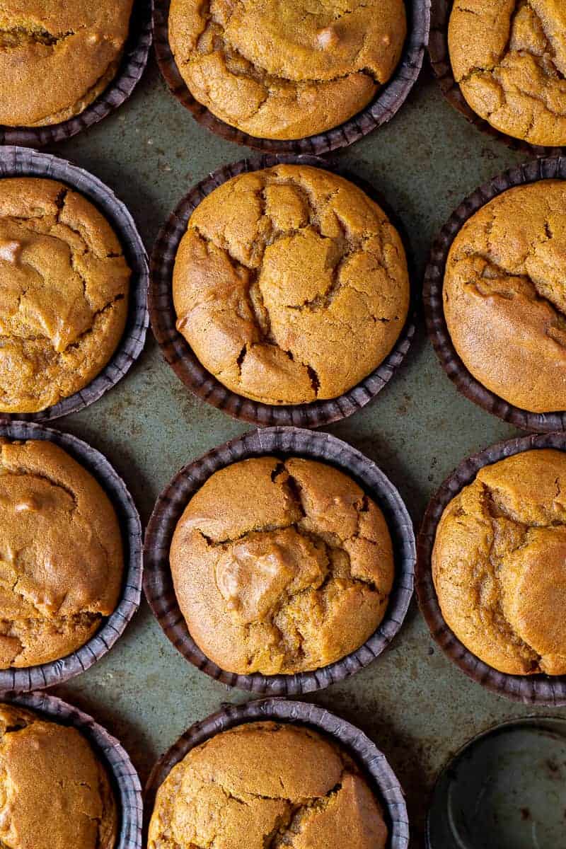 Close up of vegan pumpkin spice muffins in a metal muffin tin.