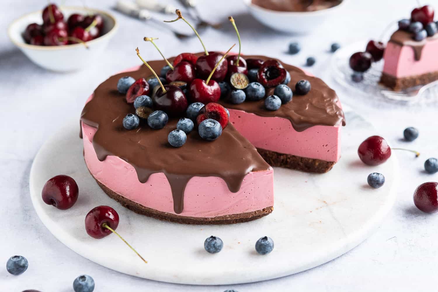 Chocolate cherry cheesecake on a marble board.