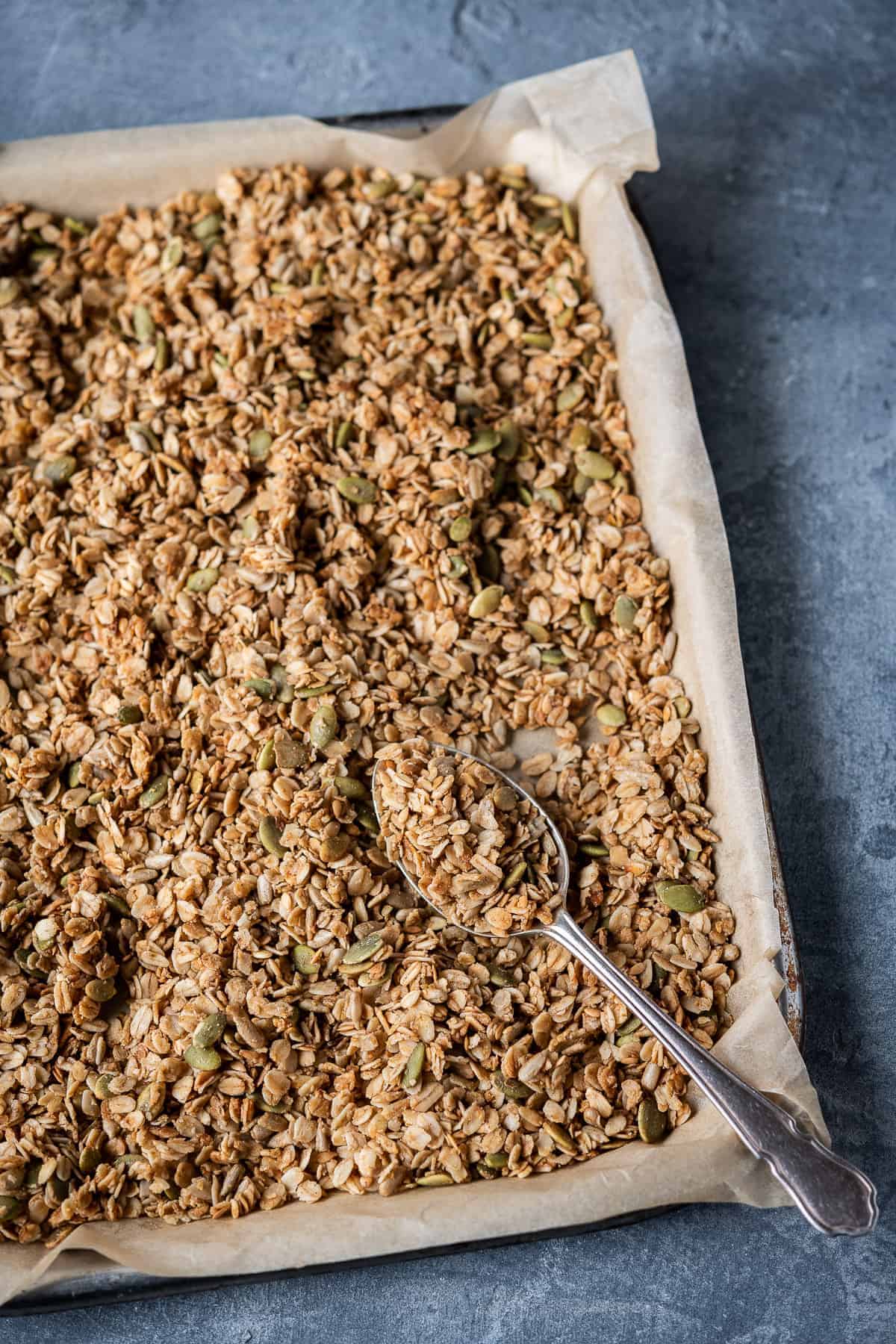 a tray of basic vegan granola on a grey background.