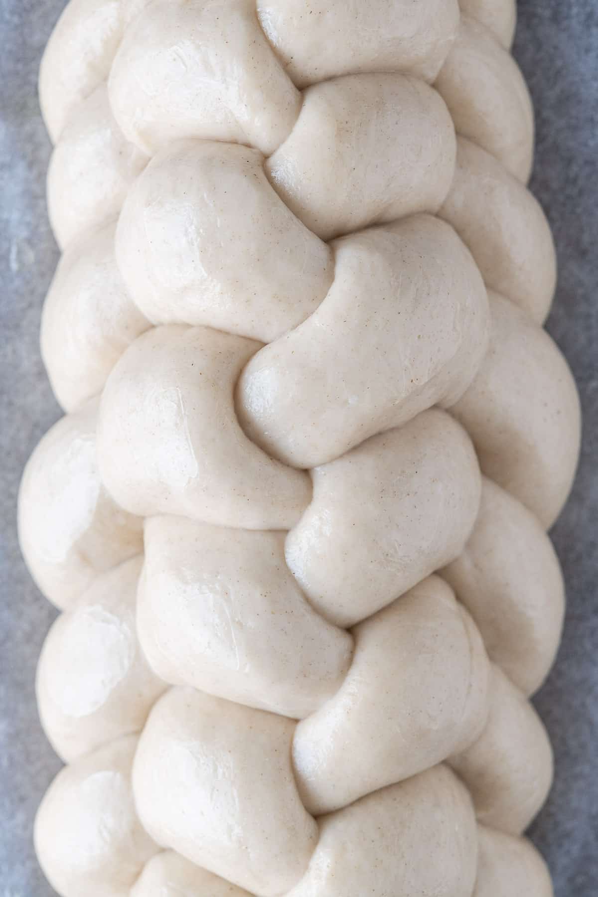 Close up of an unbaked vegan challah braid.