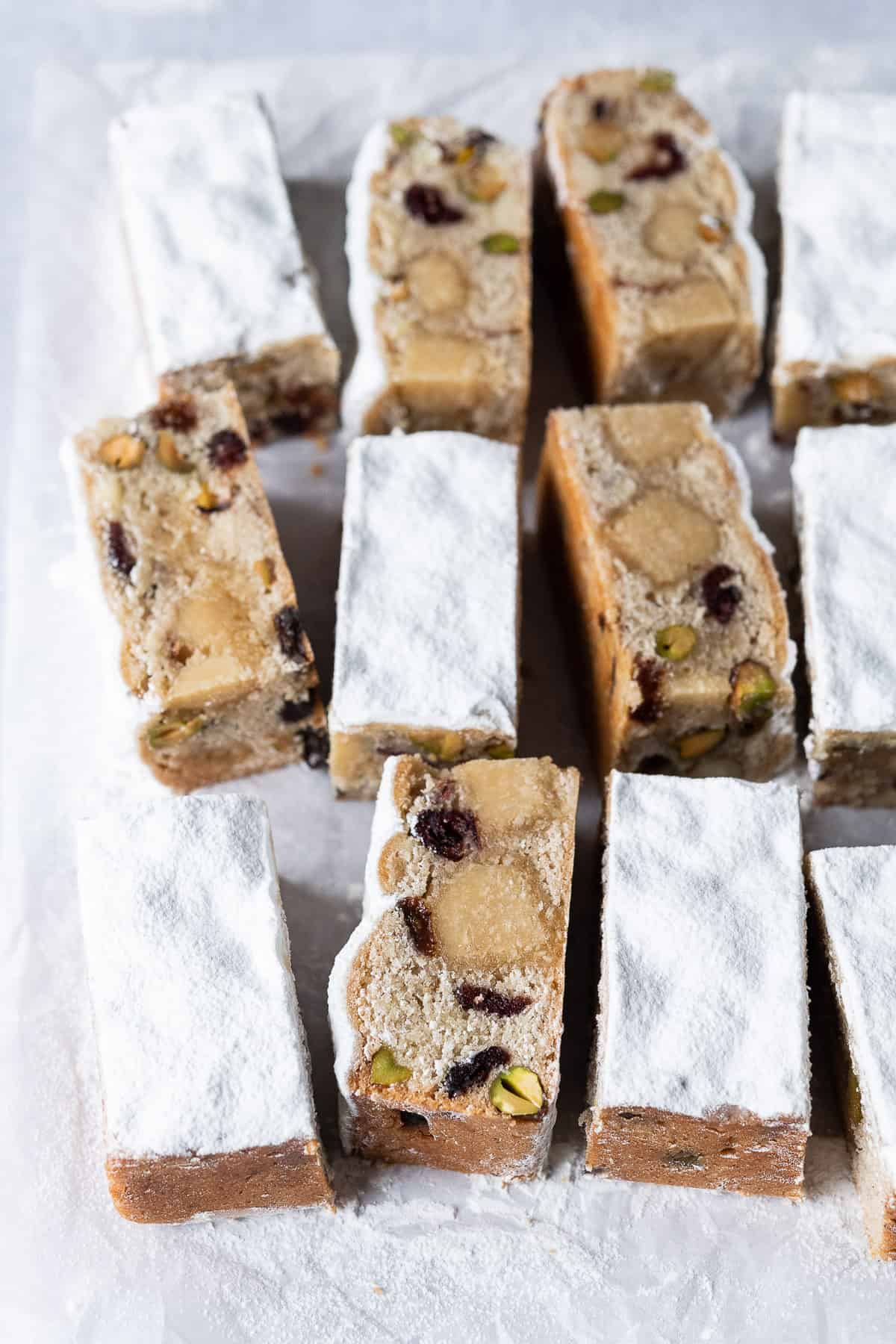 Vegan stollen bars on a sheet of white baking parchment.