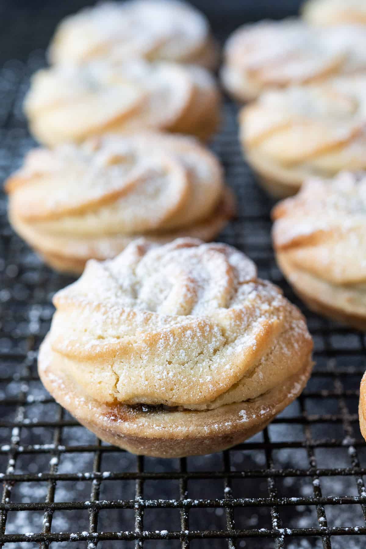 Close up of a vegan viennese whirl mince pie on a metal cooling rack.