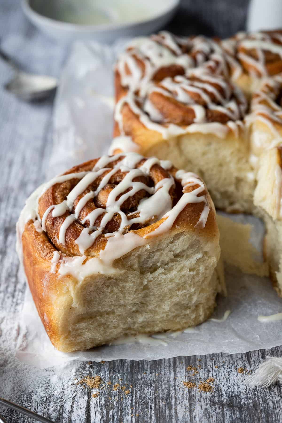 A vegan cinnamon roll on a wooden table.