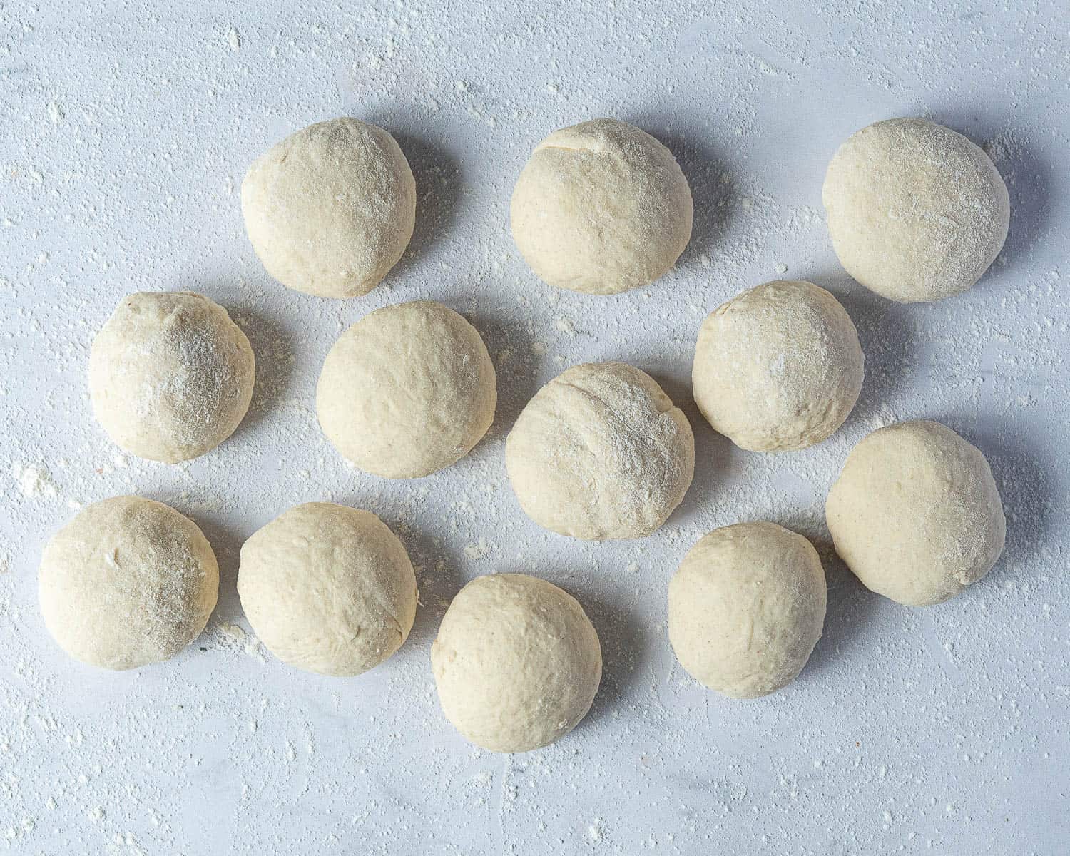 The dough divided into twelve balls.