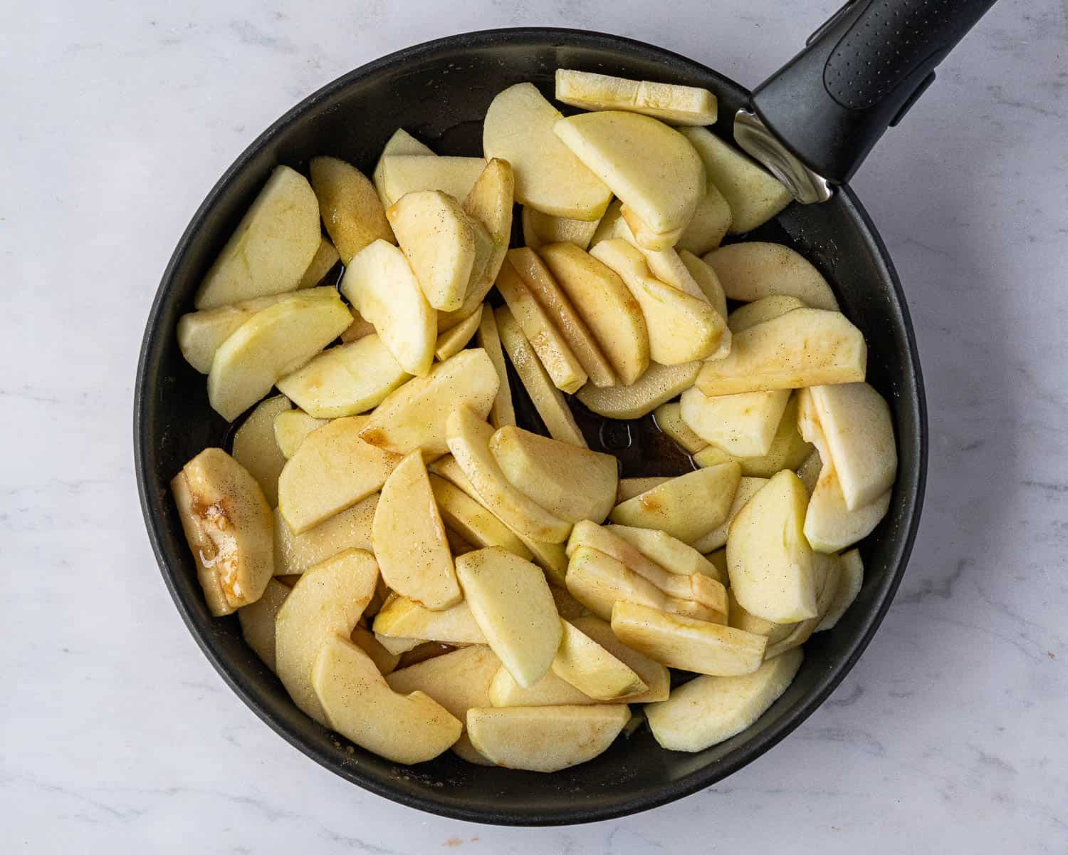 Step 1, the peeled, cored and sliced apples in a pan.