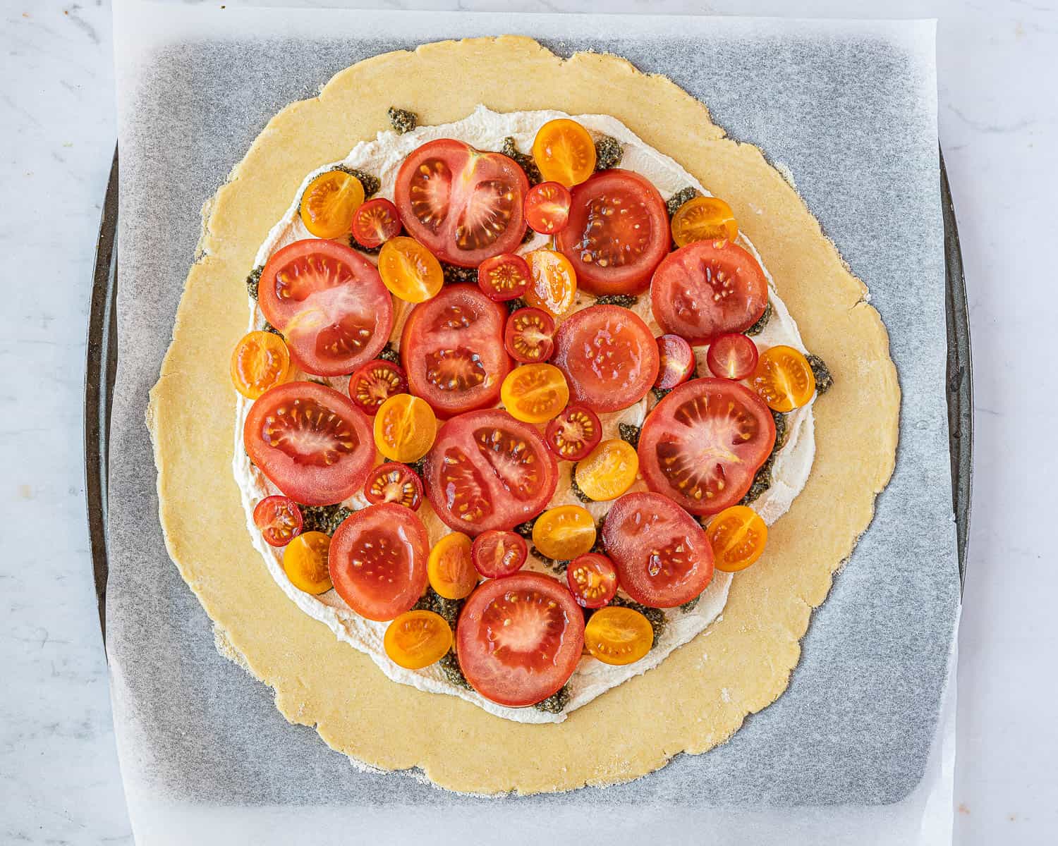 The pastry topped with tomatoes.