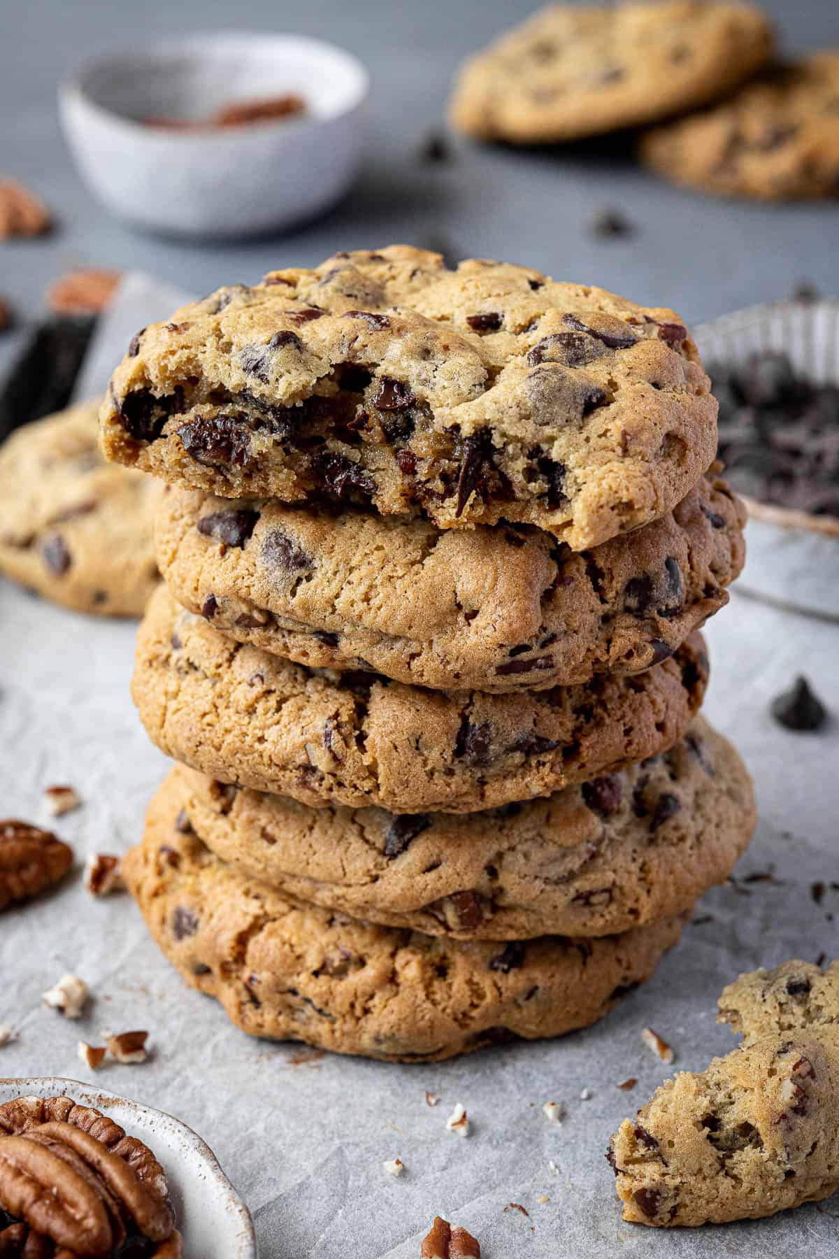 A stack of chunky chocolate pecan cookies.