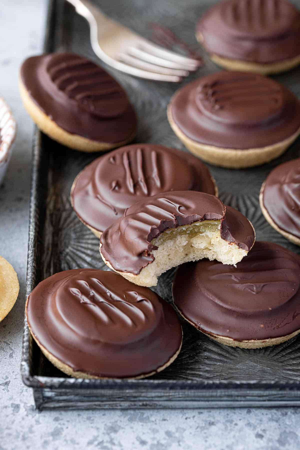 Close up of vegan jaffa cakes, one with a bite taken out of it.