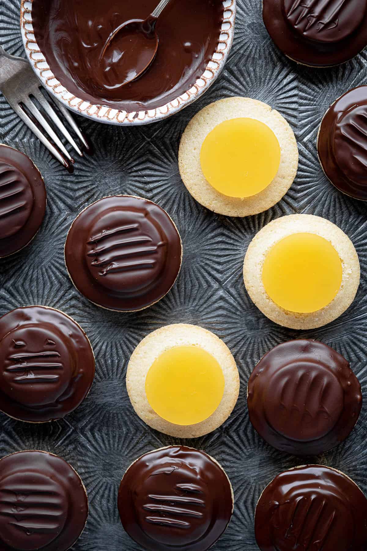 Close up of jaffa cakes, some not yet coated in chocolate.