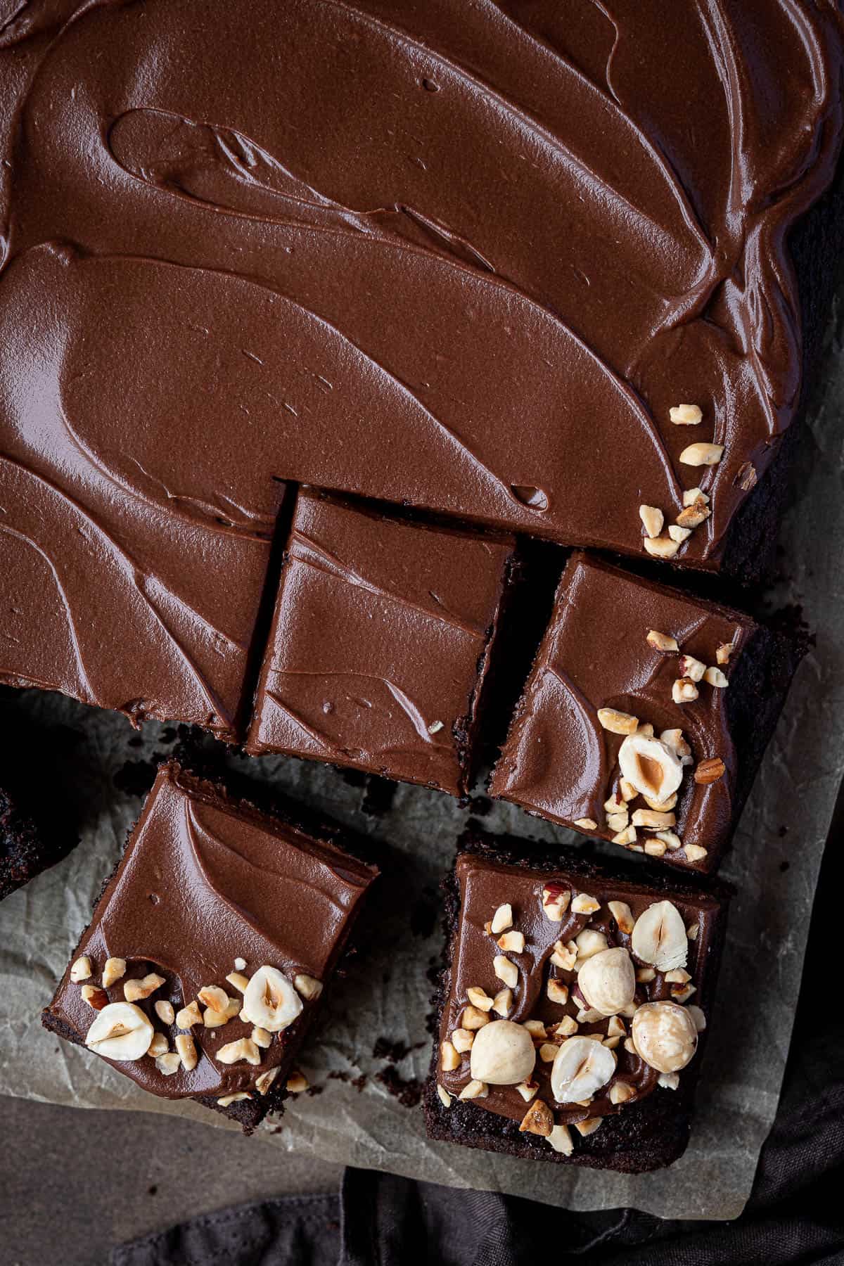 Close up of sliced vegan chocolate hazelnut cake.