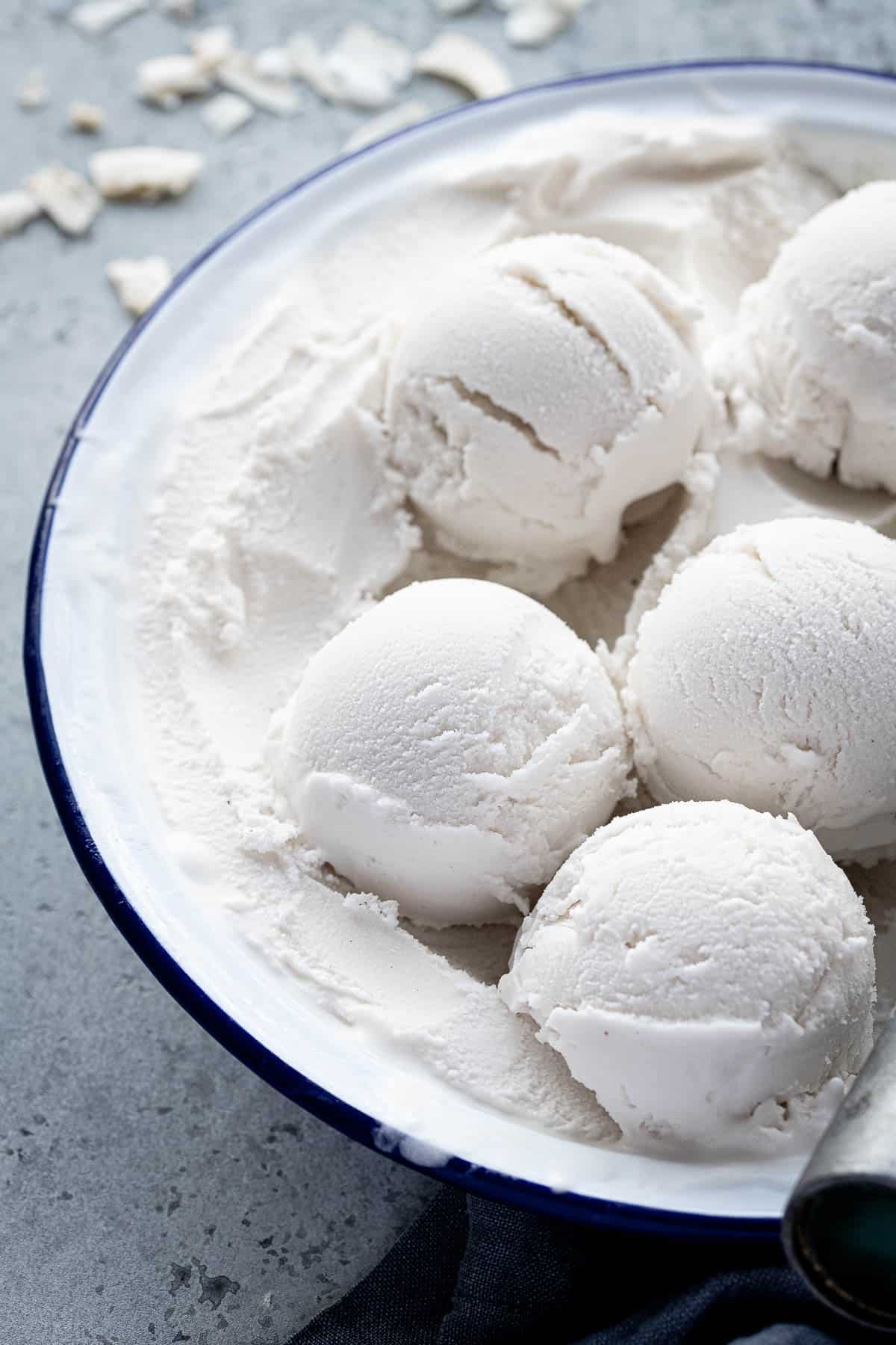 Scoops of easy coconut ice cream in a round dish.