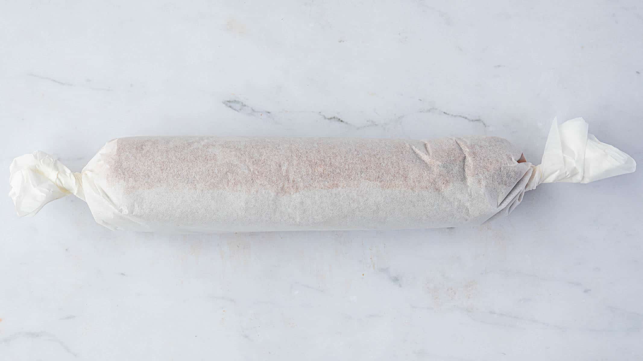 Step 5, the log rolled in baking parchment.