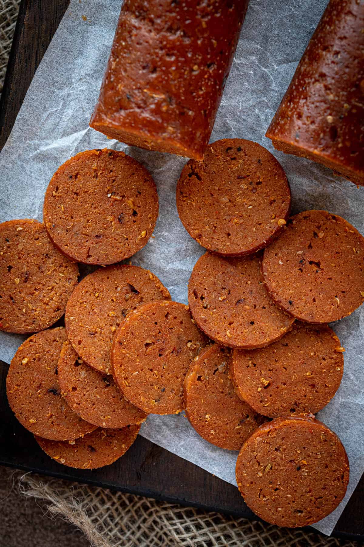 Close up of slices of seitan pepperoni.