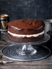 Vegan Guinness chocolate cake on a cake stand with a can of Guinness.