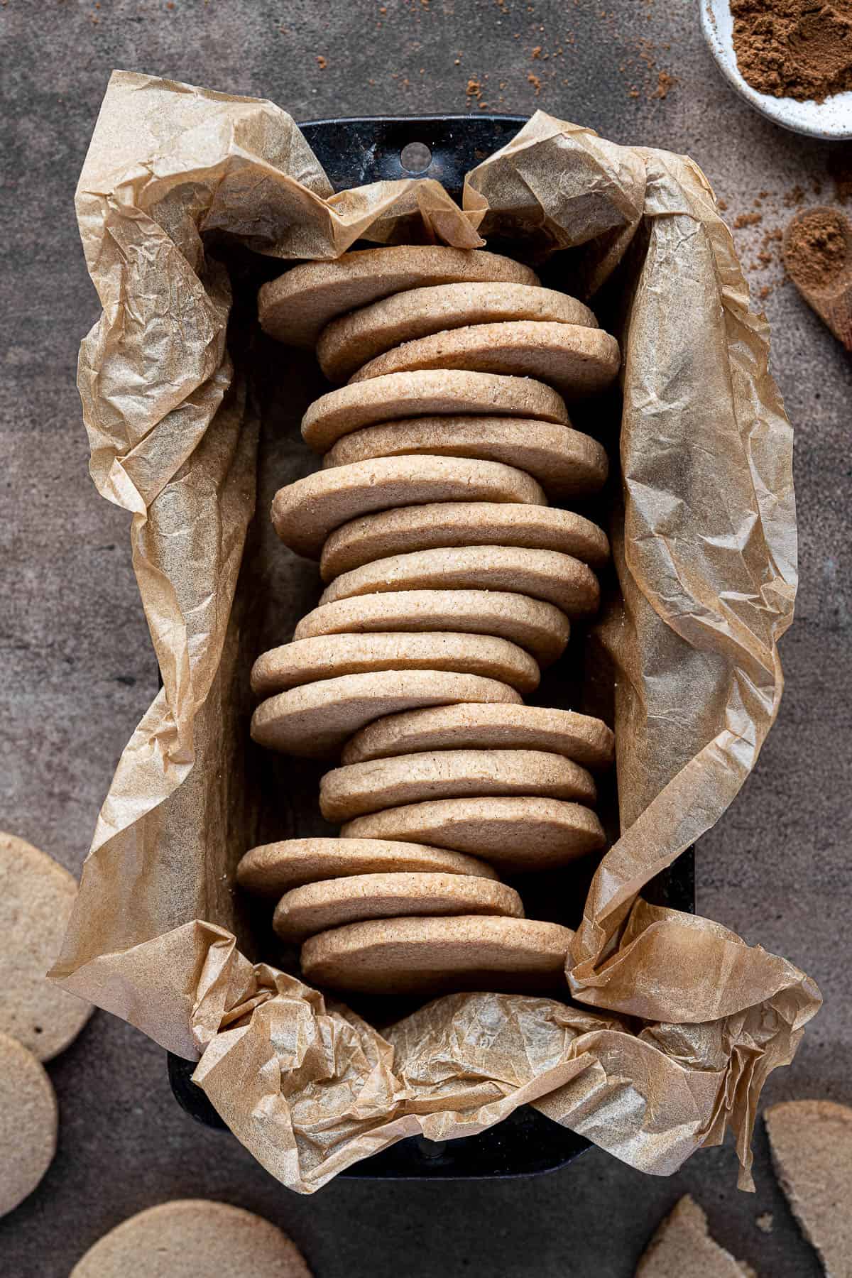 Vegan pumpkin spice shortbread coookies in a baking parchment lined loaf tin.