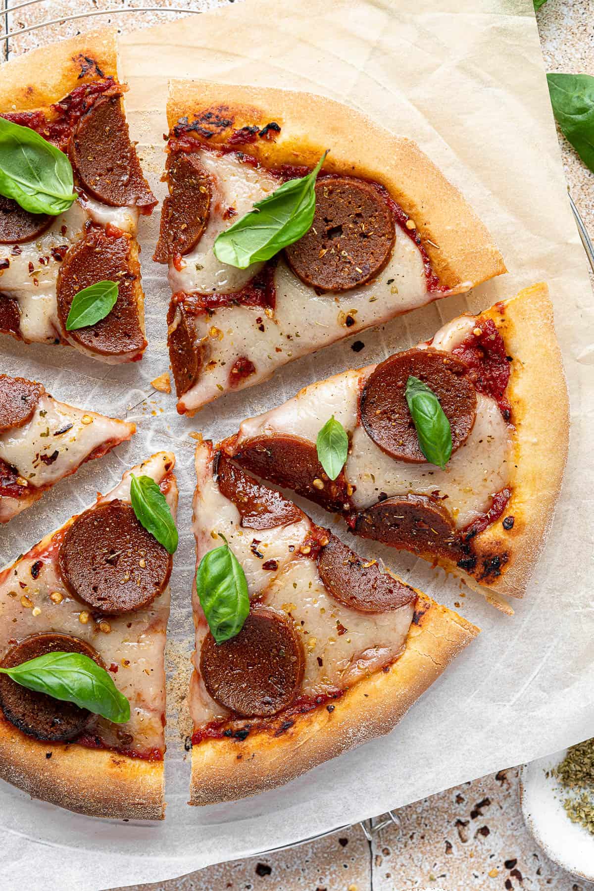 Slices of vegan pepperoni pizza.